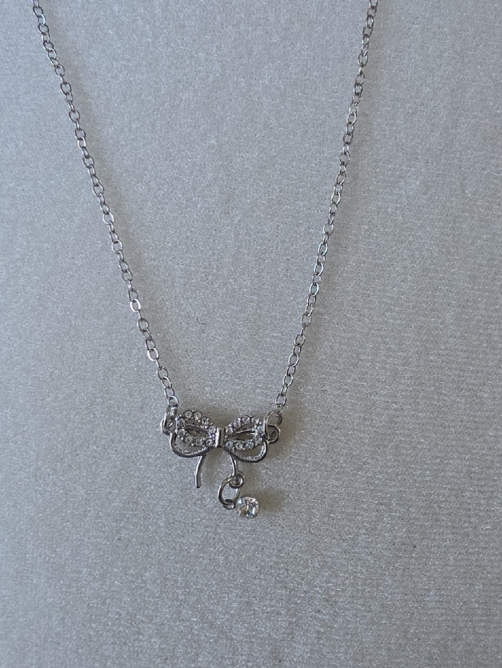 Delicate Silver Toned Bow Pendant Necklace with Crystal Accent